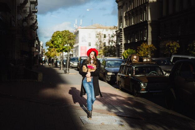 French woman with baguettes on the street in beret