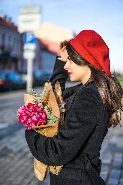 French woman with baguettes on the street in beret