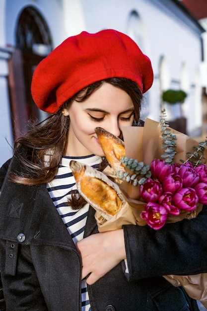 French woman with baguettes on the street in beret