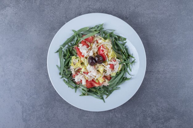 Fresh appetizing salad on white plate.