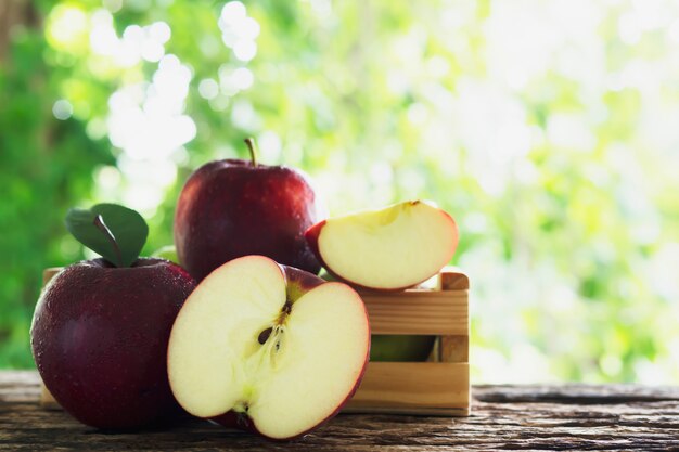 Fresh apple in wooden box over green nature , fresh fruit  