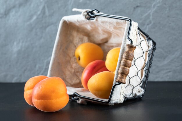 Fresh apricots in a white metallic basket