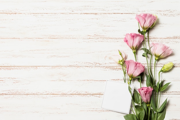 Fresh aromatic flowers near paper