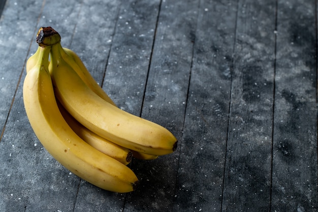 Fresh bananas on a wooden table