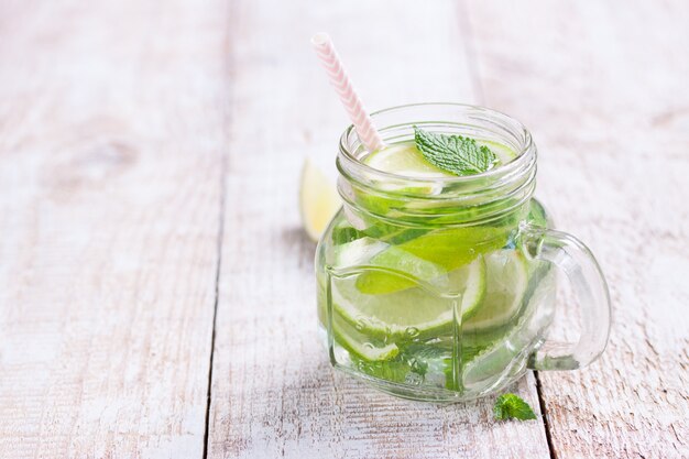 Fresh beverage with lemon and aromatic herbs