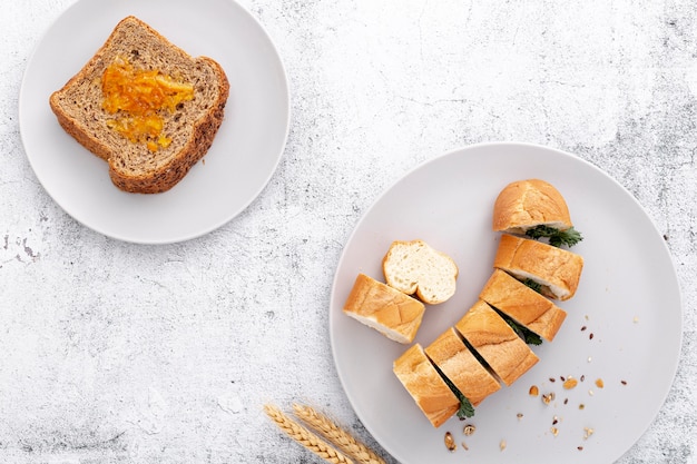 Fresh bread baguette and slices of bread top view