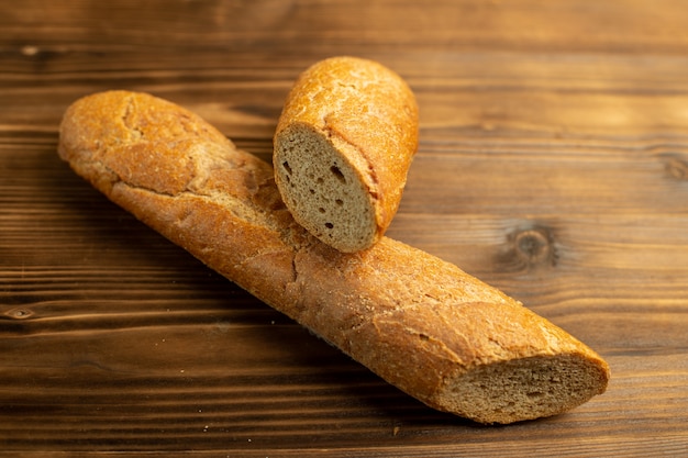 Fresh bread sliced on the wooden rustic surface