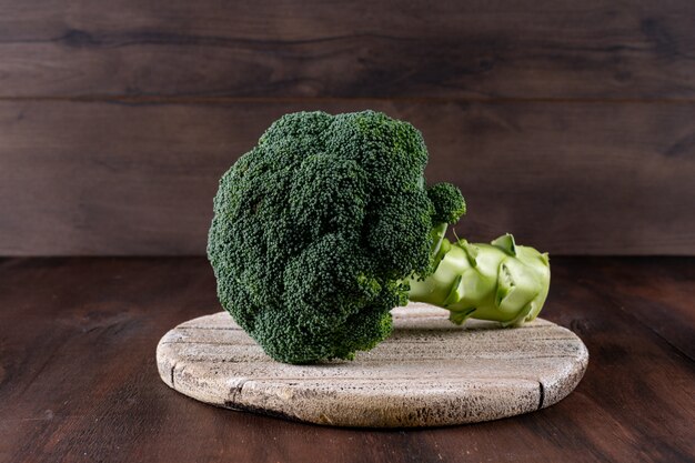 Fresh broccoli on cutting board on table