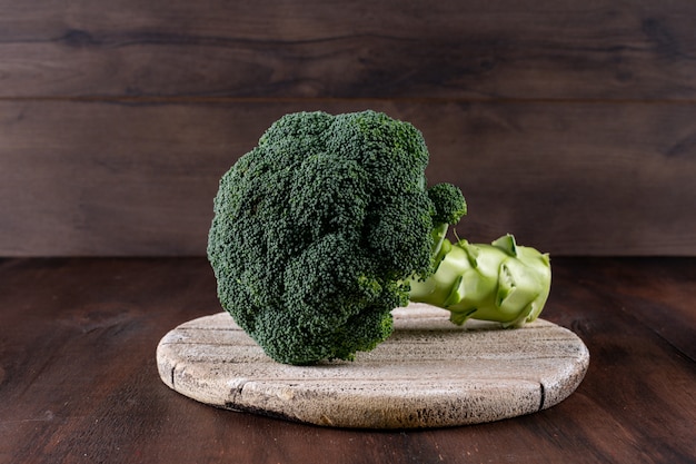 Fresh broccoli on cutting board on table