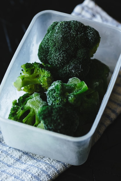 Fresh broccoli in a tray on a towel.