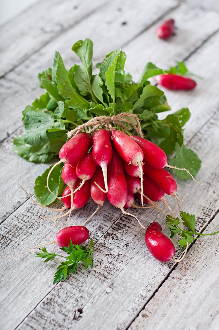 Free Photo fresh bunch of radishes on old wooden background
