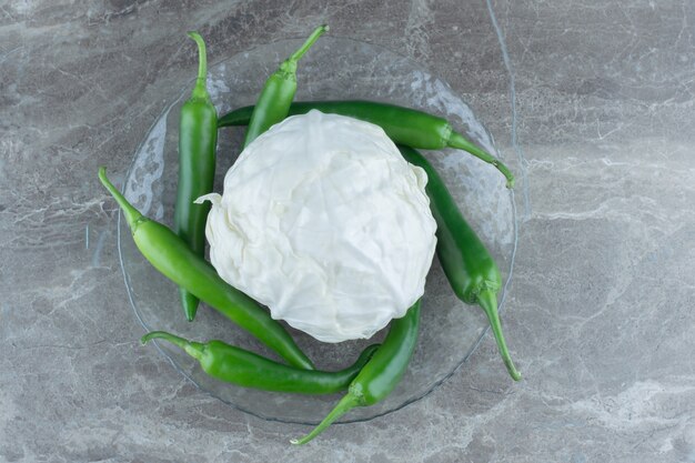 Fresh cabbage with green hot peppers. Top view. 