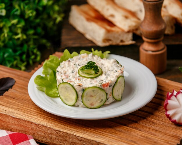 Fresh capital salad with cucumber slices