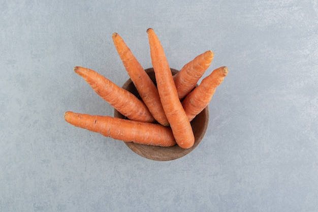 Free photo fresh carrots in the bowl , on the marble.