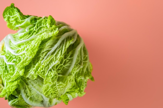 Fresh chinese cabbage on a coral table. Selective focus. Layout on the table. Healthy fresh vegetables from farms