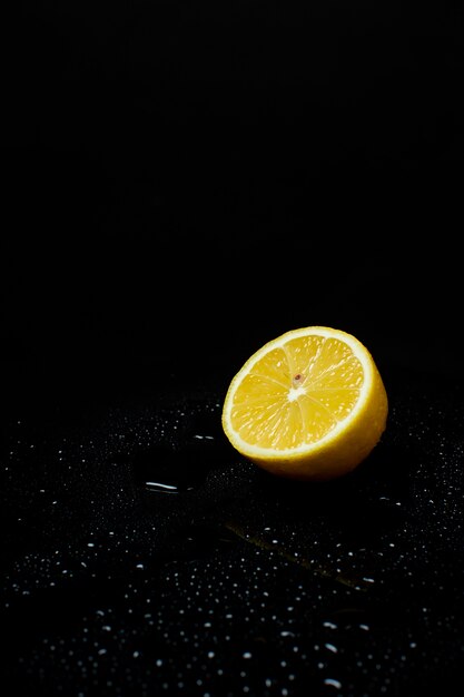 Fresh chopped yellow lemon on a black