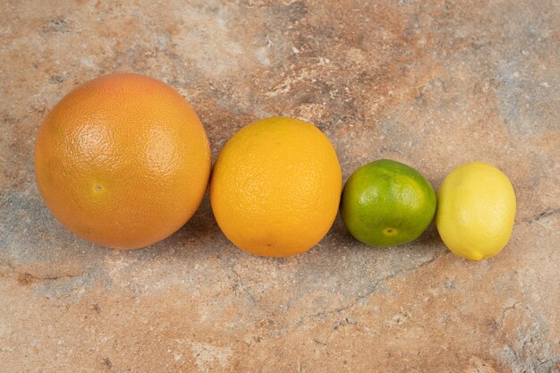 Fresh citrus fruits on marble background.