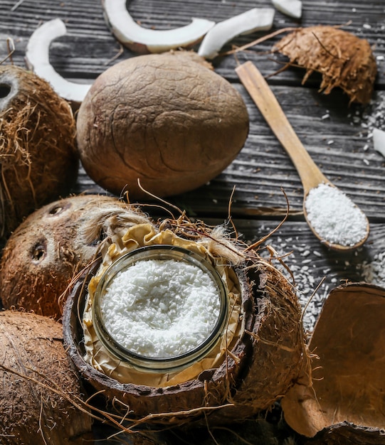 Fresh coconuts broken on wooden wall