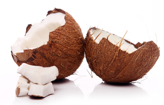 Fresh coconuts on white surface