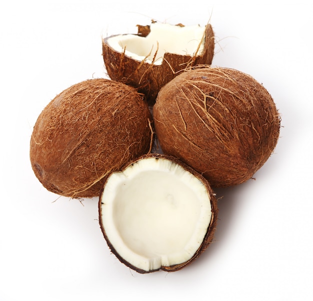 Fresh coconuts on white surface