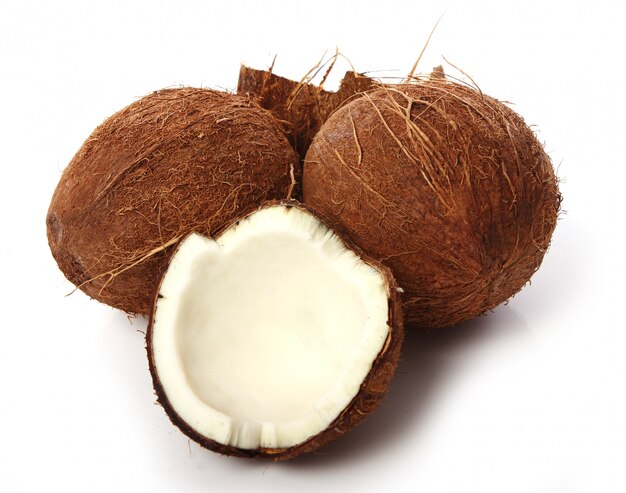 Fresh coconuts on white surface