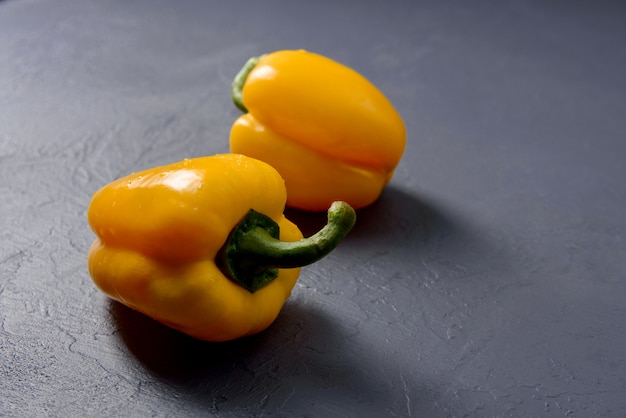 Fresh colourful paprika pepper on grey wall