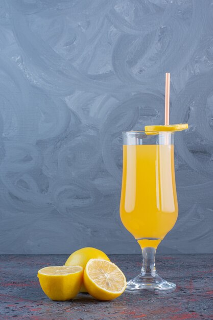 Fresh cool Lemon cocktail with lemons on gray surface