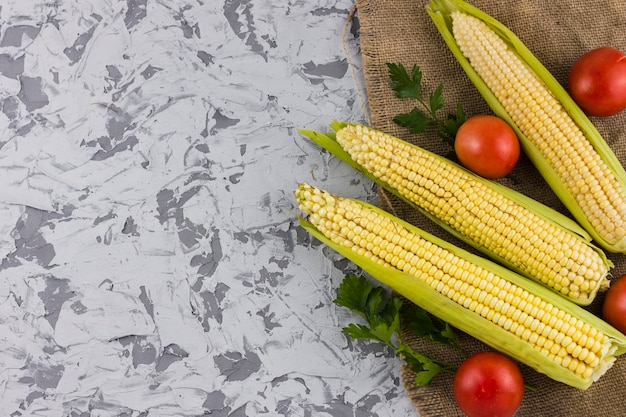Fresh corn and tomatoes with copy space