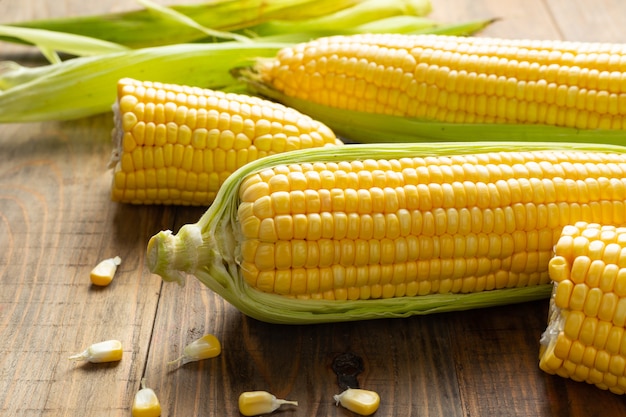 Fresh corn on wooden table.