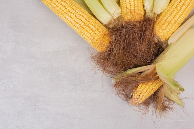 Fresh corns on cobs on white.