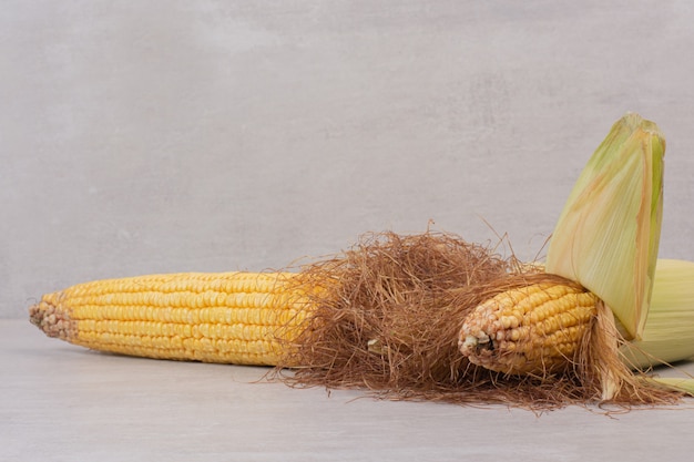 Fresh corns on cobs on white.