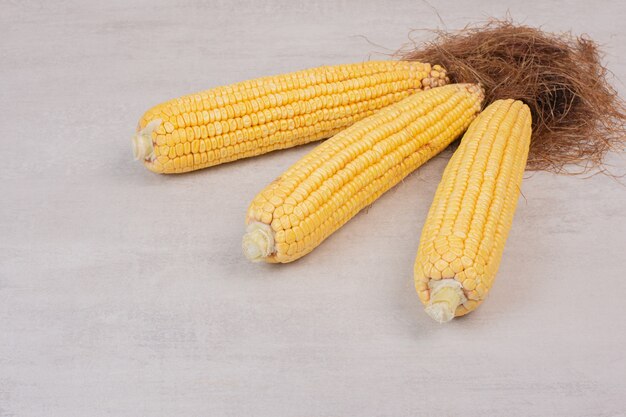 Fresh corns on cobs on white.