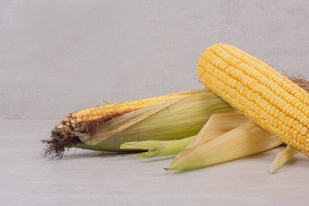 Fresh corns on cobs on white.