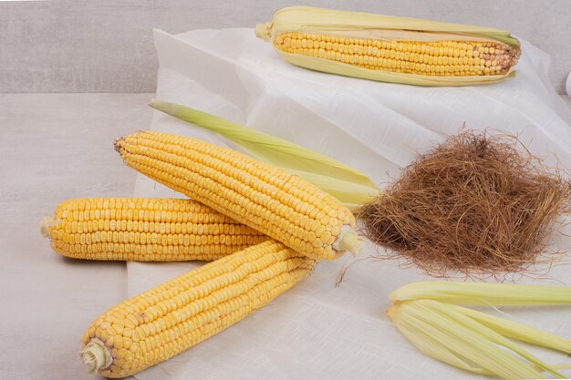 Fresh corns on cobs on white.