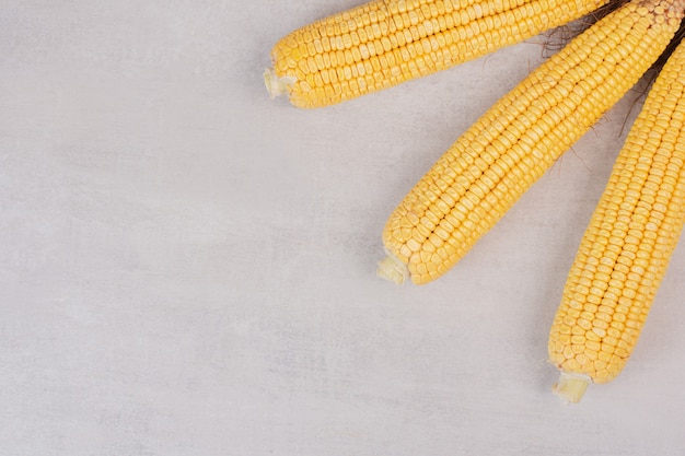 Fresh corns on cobs on white.