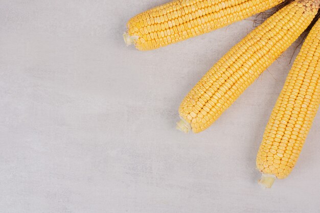 Fresh corns on cobs on white.