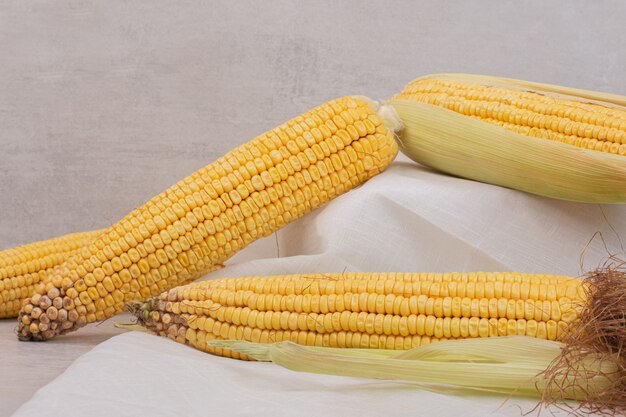 Fresh corns on cobs on white.