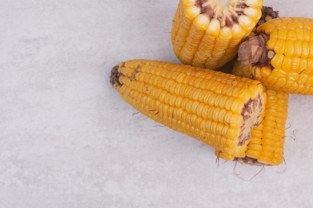 Fresh corns on white table.