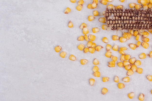 Free photo fresh corns on white table.