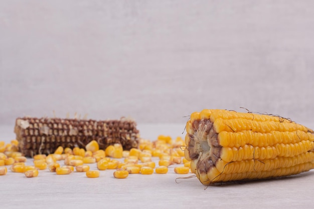 Fresh corns on white table.