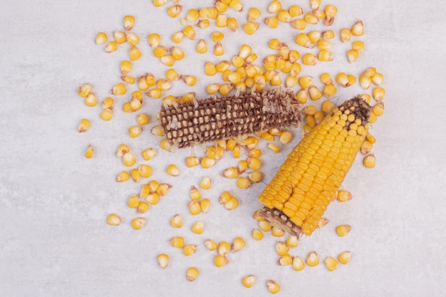 Free photo fresh corns on white table.