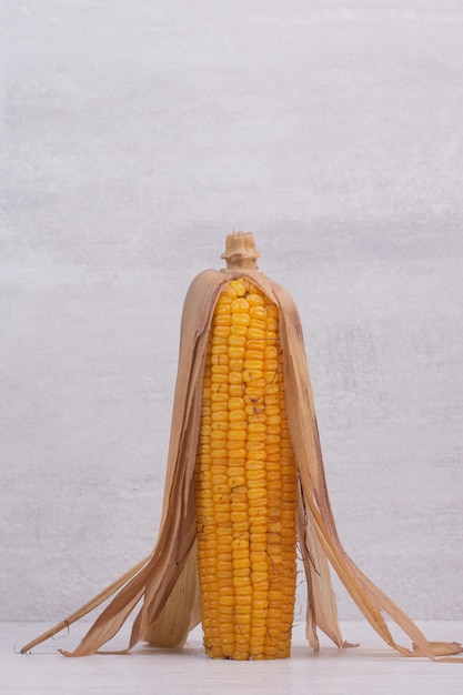 Fresh corns on white table.