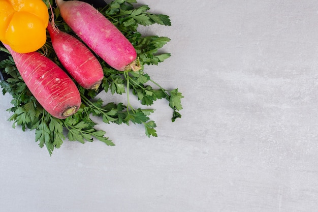 Fresh cucumbers, red radishes and pepper on black plate. High quality photo