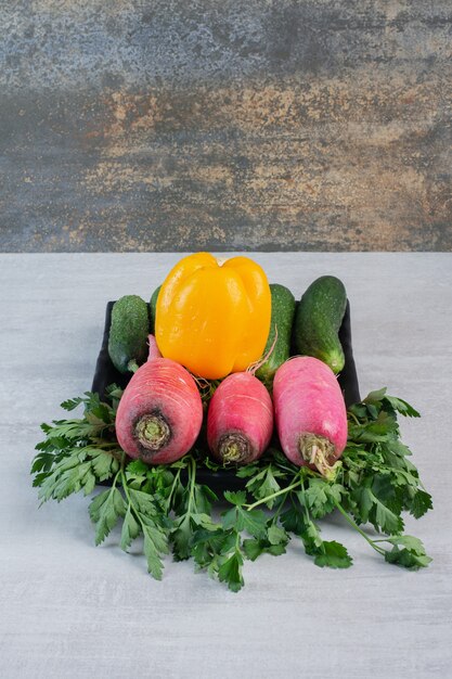 Fresh cucumbers, red radishes and pepper on stone table. High quality photo