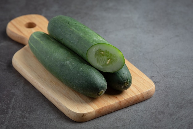 Fresh cucumbers sliced on dark background