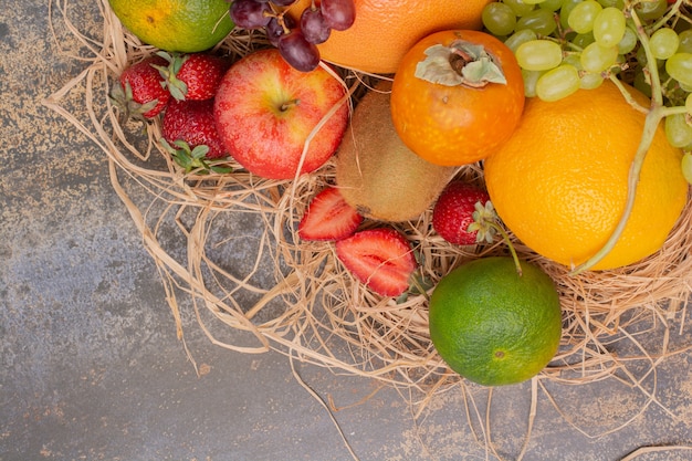 Fresh different fruits on marble surface