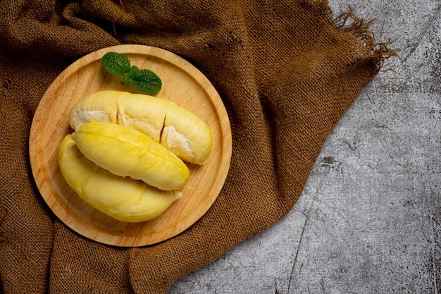 Fresh durian fruit on the dark surface.