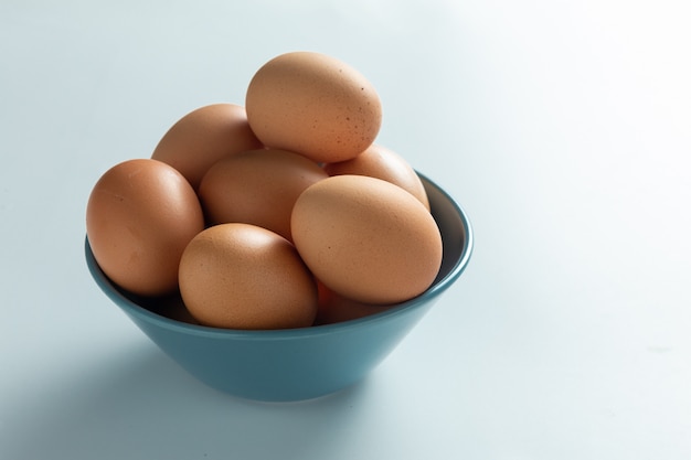 Fresh eggs in bowl.