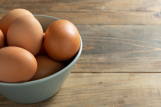 Fresh eggs in bowl.