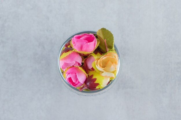 Fresh elegant flowers in a glass, on the white background. High quality photo